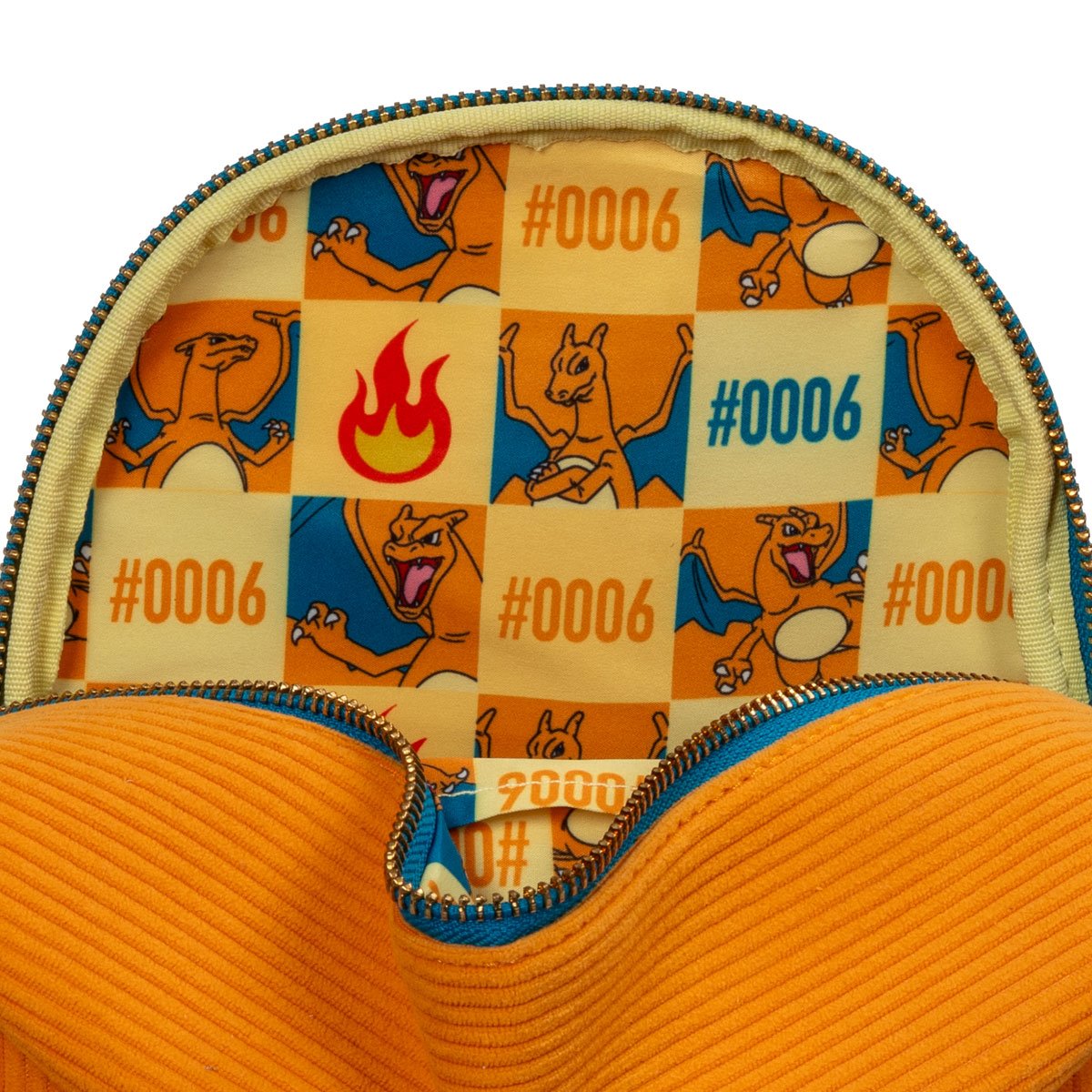 Interior of Charizard mini‑backpack showing yellow and orange printed lining with Charizard character pattern and Pokédex number 0006.