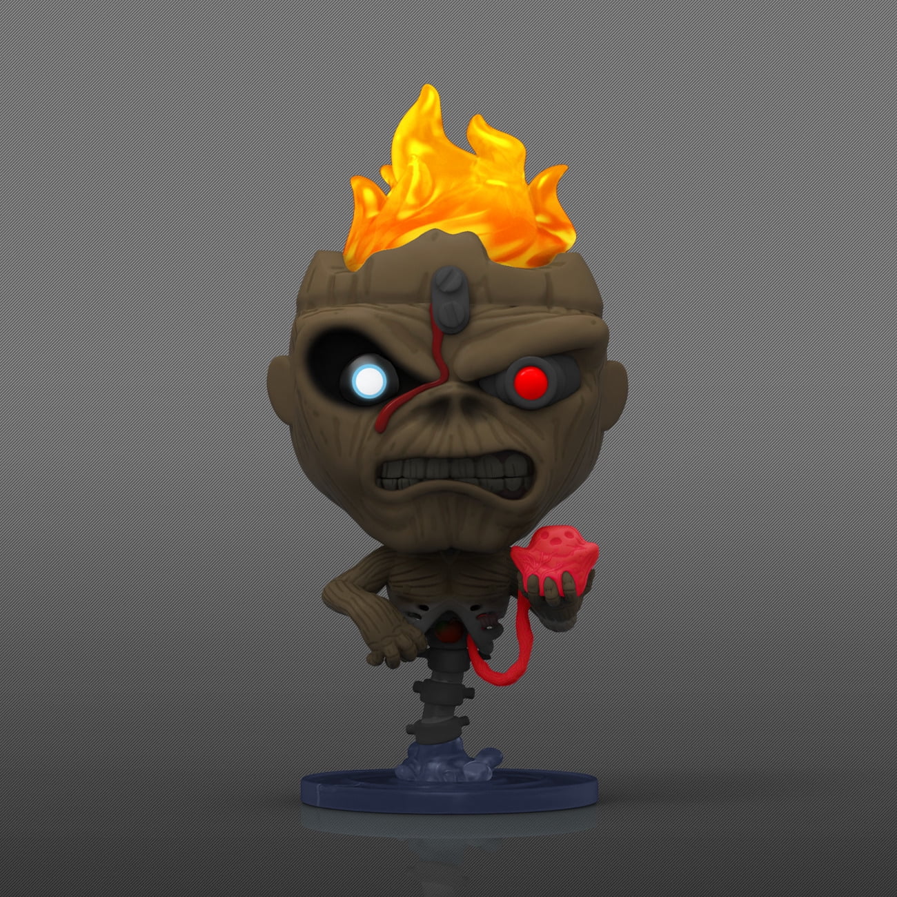 Toy figure with flame on head and red object in hand against gray background