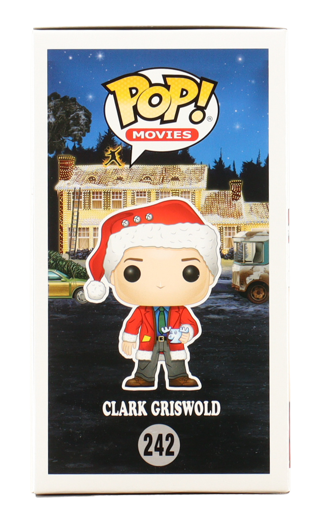 Funko Pop! Movies figure of Clark Griswold in a Christmas-themed box with a house and car in the background.