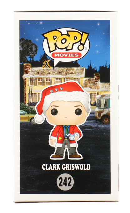 Funko Pop! Movies figure of Clark Griswold in a Christmas-themed box with a house and car in the background.