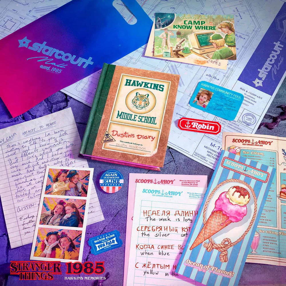 Collection of 'Stranger Things' themed items including a diary, postcards, and promotional materials on a textured surface.